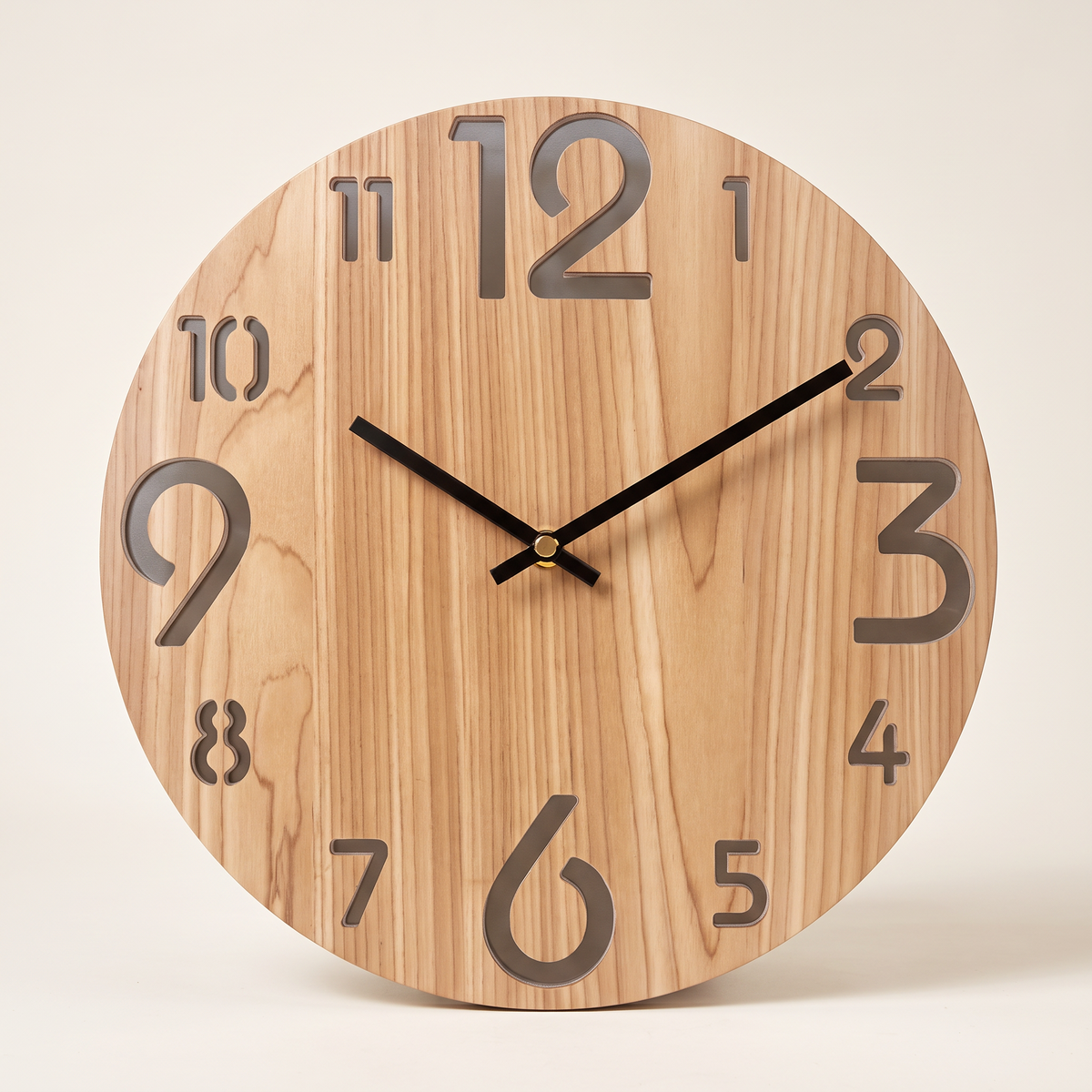 Nordic wooden wall clock on a plain background